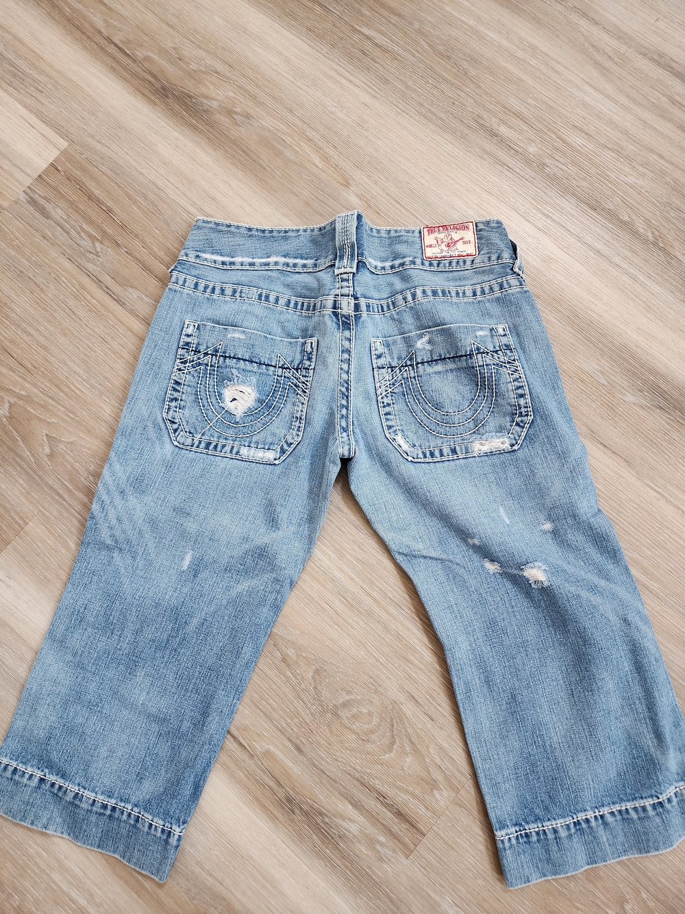 True Religion light blue denim jeans with red logo patch
